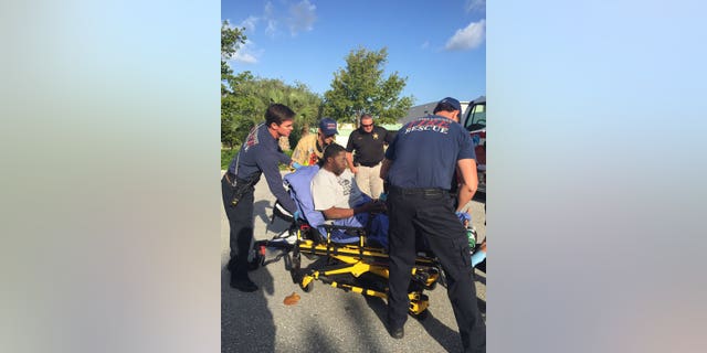 Paramedics tending to Robert Stewart.