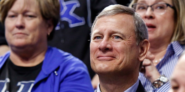 Chief Justice of the U.S. Supreme Court John Roberts watches the first half of an NCAA college basketball game between Kentucky and Georgia, Tuesday, Jan. 31, 2017, in Lexington, Ky. (AP Photo/James Crisp)