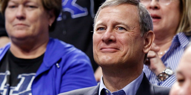 Chief Justice of the U.S. Supreme Court John Roberts watches the first half of an NCAA college basketball game between Kentucky and Georgia, Tuesday, Jan. 31, 2017, in Lexington, Ky. (AP Photo/James Crisp)