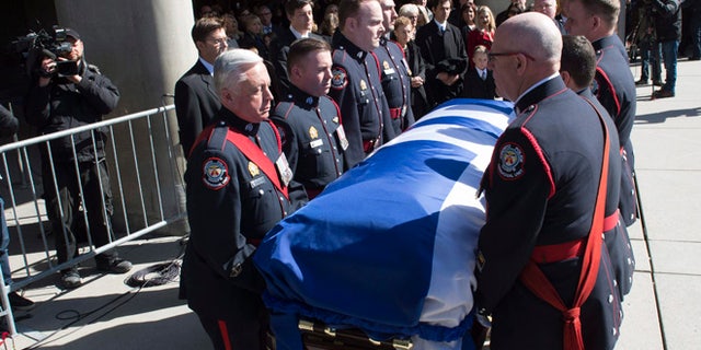 Pallbearers carry the casket of former Toronto mayor Rob Ford from city hall during his funeral procession to St. James Cathedral in Toronto on Wednesday.