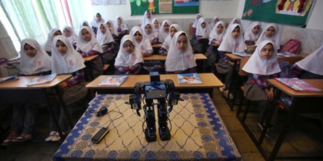 Feb. 24, 2014: Veldan, a humanoid praying robot which is built by Iranian schoolteacher Akbar Rezaie, performs morning prayer in front of Alborz elementary school girls in the city of Varamin some 21 miles south of the capital Tehran, Iran.