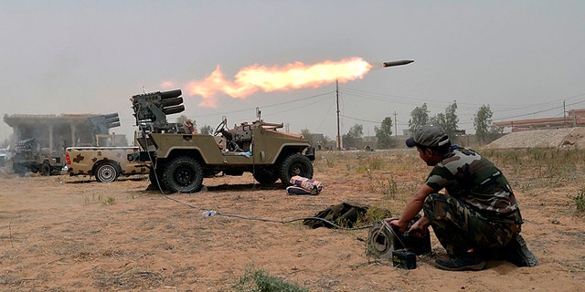 Iraqi forces fire rockets during battle against Islamic State.