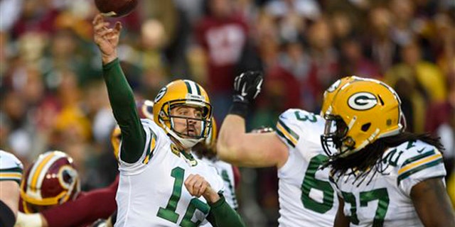 Green Bay Packers quarterback Aaron Rodgers (12) throws a pass during the first half of an NFL wild card playoff football game against the Washington Redskins in Landover, Md., Sunday, Jan. 10, 2016. (AP Photo/Nick Wass)
