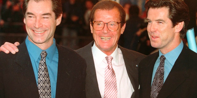 File - In this Sunday, Nov. 17, 1996 file photo, three of the actors who played James Bond, Timothy Dalton left, Roger Moore, center, and Pierce Brosnan, at a London cinema to celebrate the life of Albert R.