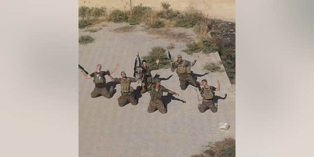 Western volunteers with the YPG posing at their base in the Rojava region of Syria.