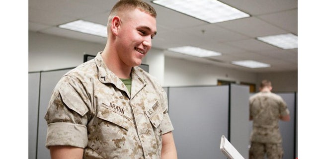 Marine Pfc. Austin Braun talks to a reporter about rolling sleeves at Fort Myer, Va., in 2014. (U.S. Army)