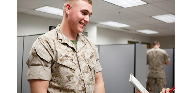 Marine Pfc. Austin Braun talks to a reporter about rolling sleeves at Fort Myer, Va., in 2014. (U.S. Army)