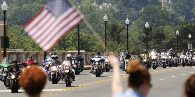 Motorcycle riders take part in the annual Rolling Thunder demonstration, crossing the Memorial Bridge in front of Arlington Cemetery to pay their respects at the Vietnam Veterans Memorial in Washington, May 30, 2010. (Reuters)