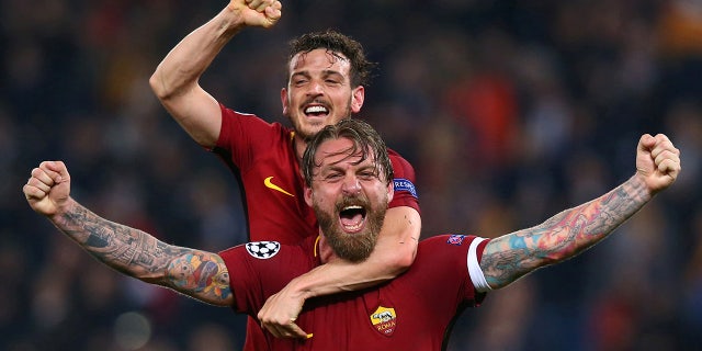 Roma's Daniele De Rossi and Alessandro Florenzi celebrate after the match against Barcelona at the Stadio Olimpico in Rome, Italy.