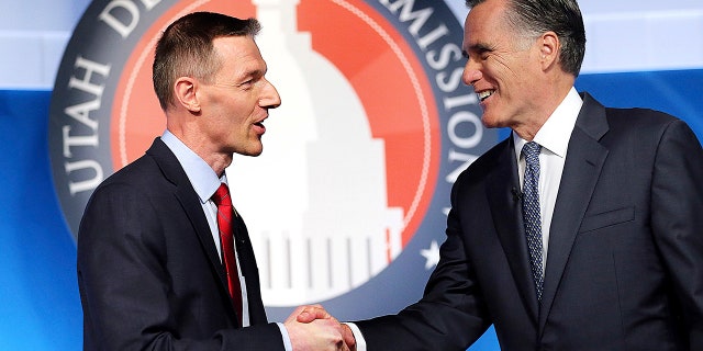 Utah Senate candidates, state Rep. Mike Kennedy, R-Alpine, left, and former Massachusetts Gov. Mitt Romney shake hands at the beginning of a Senate Republican primary debate, May 29 in Provo, Utah.