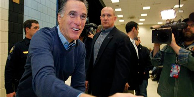 Feb. 11, 2012: Mitt Romney greets supporters at a caucus in Portland, Maine.