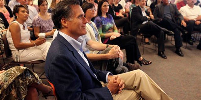 Former Massachusetts Gov. Mitt Romney waits while he is introduced to employees at Lincoln Financial Group in Concord, N.H., June 27.