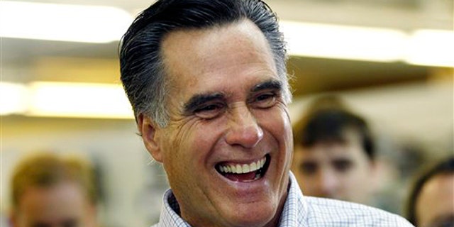 Former Massachusetts Gov. Mitt Romney laughs during a campaign stop at a hardware store in Derry, N.H., June 14.
