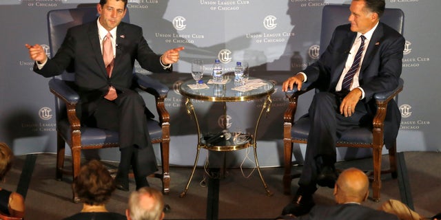 Aug. 21, 2014: Former Massachusetts Gov. Mitt Romney, right, listens to the response of his former vice-presidential running mate U.S. Rep. Paul Ryan, R-Wis., during an interview about Ryan's new book.