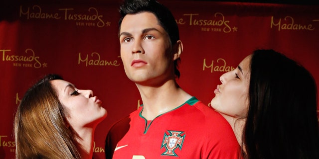 Fans get close to the Cristiano Ronaldo wax figure at Madame Tussauds in New York City. (Photo by Cindy Ord/Getty Images for Madame Tussauds New York)
