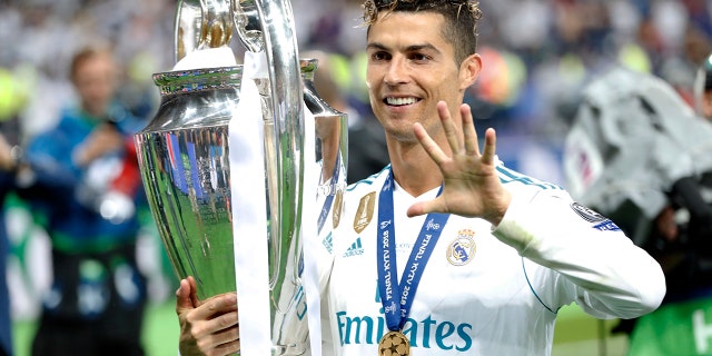 Real Madrid's Cristiano Ronaldo celebrates with the trophy after winning the Champions League Final soccer match between Real Madrid and Liverpool at the Olimpiyskiy Stadium in Kiev, Ukraine, May 26, 2018
