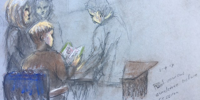 Dylann Roof reviewing evidence in court.