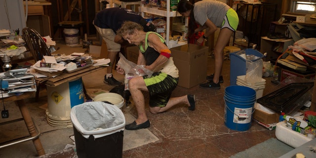 Rosalea Nall and volunteers work to clean up and rebuild her devastated home.