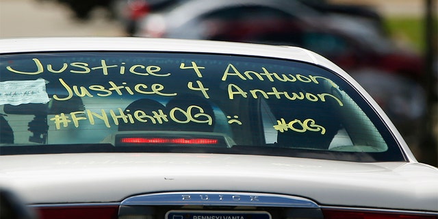 One of the vehicles in the funeral procession for Antwon Rose Jr. has a message displayed as it arrives at the Woodland Hills Intermediate school.
