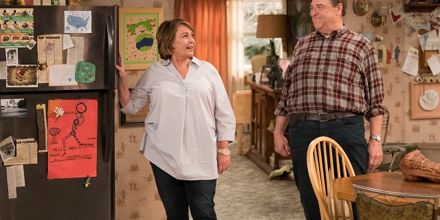 This image released by ABS shows Roseanne Barr, left, and John Goodman in a scene from the comedy series "Roseanne." ABC's "Roseanne" revival is in the running for Emmy nominations Thursday, but will TV academy voters overlook its star's racist tweet that brought the sitcom to an abrupt end?