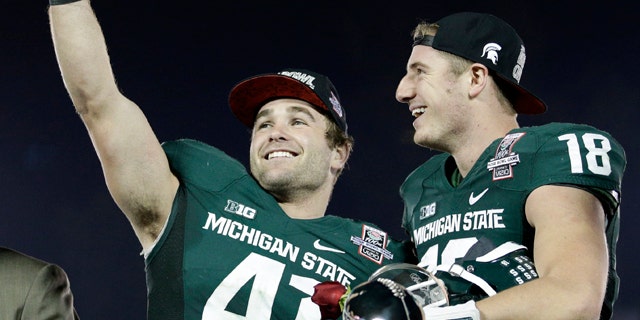 Jan. 1, 2014: Michigan State linebacker Kyler Elsworth, left, celebrates with quarterback Connor Cook after Michigan State defeated Stanford 24-20 in the Rose Bowl NCAA college football game.