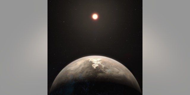 An artist's impression of the temperate planet Ross 128 b, with its red dwarf parent star in the background.