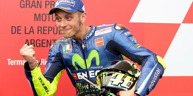 FILE -- In this April, 9, 2017 file photo, Italy's Valentino Rossi celebrates winning second place at the end of the MotoGP race of Argentina's Motorcycle Grand Prix at the Termas de Rio Hondo circuit in Argentina. Six-time MotoGP champion Rossi has reportedly broken his right leg in a training accident in Italy. According to Italian sports daily Gazzetta dello Sport, Rossi fell during enduro training and fractured his tibia and fibula. (AP Photo/Nicolas Aguilera)