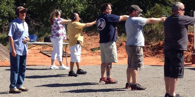 Concealed weapons instructor Roy Jones with students on his shooting range in Oklahoma.