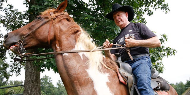 Former Alabama Chief Justice and U.S. Senate candidate Roy Moore, rides in on a horse named "Sassy" to vote a the Gallant Volunteer Fire Department, during the Alabama Senate race, Tuesday, Aug. 15, 2017, in Gallant, Ala. (AP Photo/Brynn Anderson)