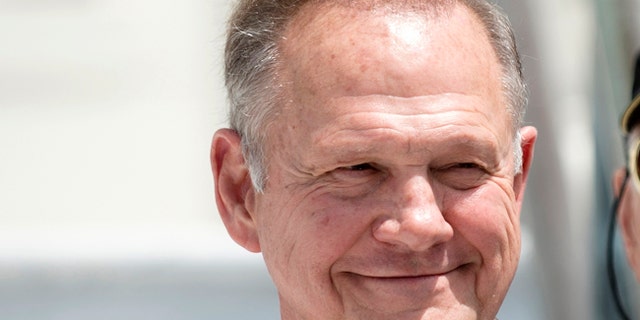 FILE -In this April 26, 2017 file photo, Roy Moore smiles before announcing his Alabama Junior Senate race candidacy, in Montgomery, Ala. As former Alabama Chief Justice Roy Moore, runs for U.S. Senate, he doesn't shrink from telling voters he has twice been ousted from the bench for defying federal courts over the Ten Commandments and same-sex marriage. Instead, he wears those rejections as a badge of honor. (Albert Cesare/The Montgomery Advertiser via AP, File)