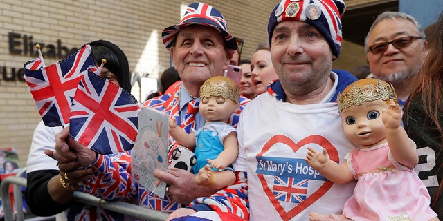 Royal fans John Loughrey, right, and Terry Hutt pose for a photo opposite the Lindo wing at St Mary's Hospital in London London, Monday, April 23, 2018.