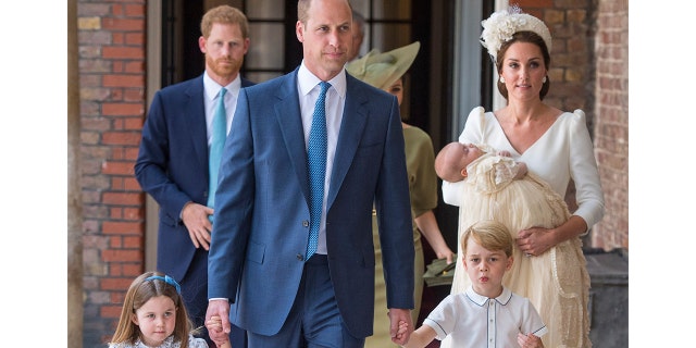Princess Charlotte and Prince George hold the hands of their father Prince William while Kate, Duchess of Cambridge holds Prince Louis as they arrive for his christening service at the Chapel Royal, St James's Palace, London, Monday, July 9, 2018. (Dominic Lipinski/Pool Photo via AP)