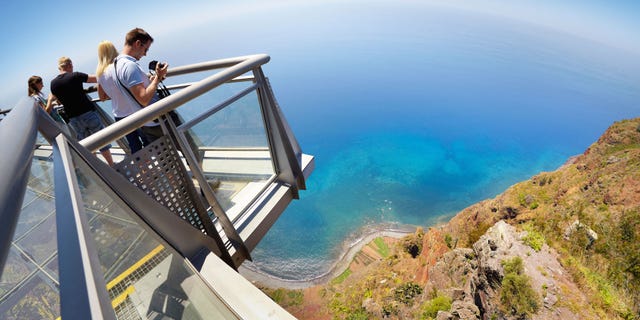 DAX3AN Tourist on the panoramic terrace at the top of Cabo Girao (580 m highest) cliff - Camara de Lobos, Madeira, Portugal