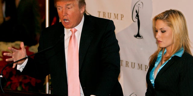 Miss USA Tara Conner listens to Donald Trump (L) during the announcement that she will not be losing her crown, in New York, December 19, 2006. Billionaire Donald Trump told Miss USA 2006 Tara Conner on Tuesday she would be given a second chance after reported misbehavior. Media reports of blond beauty queen Conner partying at bars and nightclubs in New York -- where the legal drinking age is 21 -- began surfacing last week. REUTERS/Lucas Jackson (UNITED STATES) - RTR1KKBY