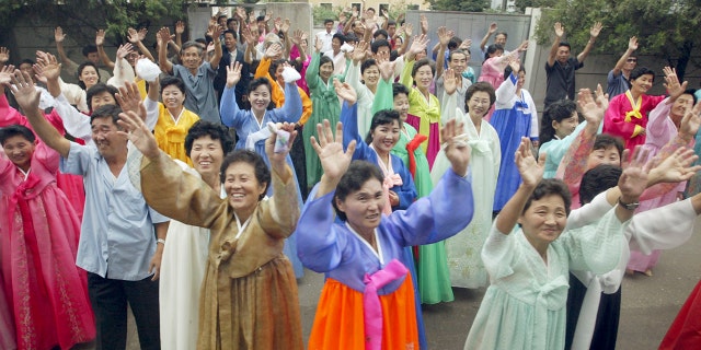North Koreans wave to South Koreans after they read joint mass with
South Koreans at a Catholic church in Pyongyang.