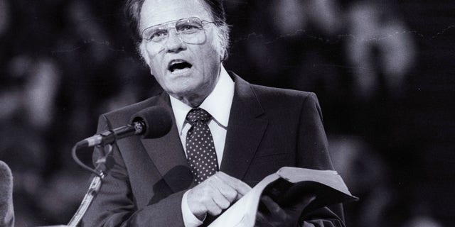 FILE -- US evangelist Billy Graham preaches the Gospel to thousands of believers during tonight's meeting at Bercy's Stadium in Paris as part of a worldwide crusade, September 20, 1986.