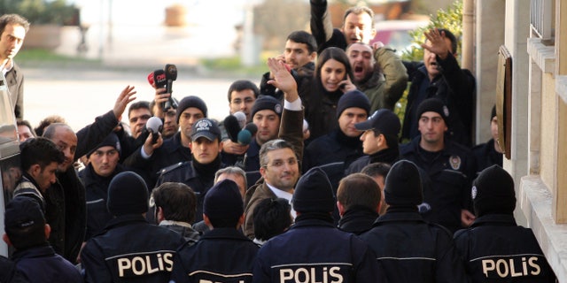 Ahmet Sik (facing camera, third from left) outside an Istanbul courthouse in 2011.