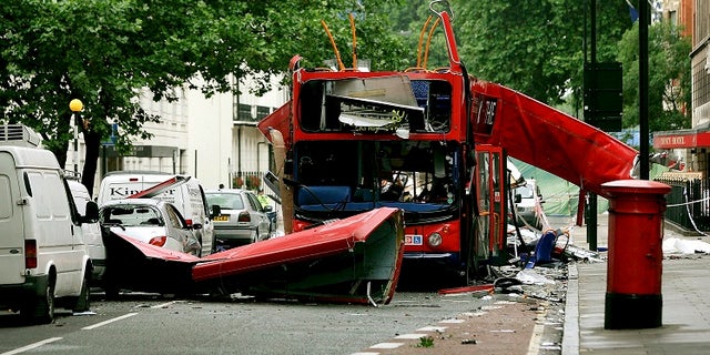 Debris is seen around the destroyed double decker bus after it was struck by a bomb in London in 2005.