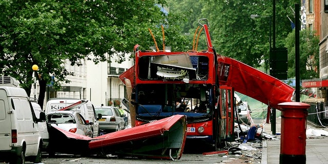 Debris is seen around the destroyed double decker bus after it was struck by a bomb in London in 2005.