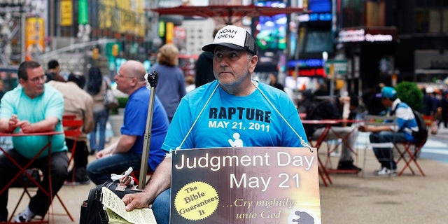 A volunteer from the religious group Family Radio hands out pamphlets warning of the impending Judgment Day. Harold Camping, an evangelist, predicted the end times would begin May 21, 2011.