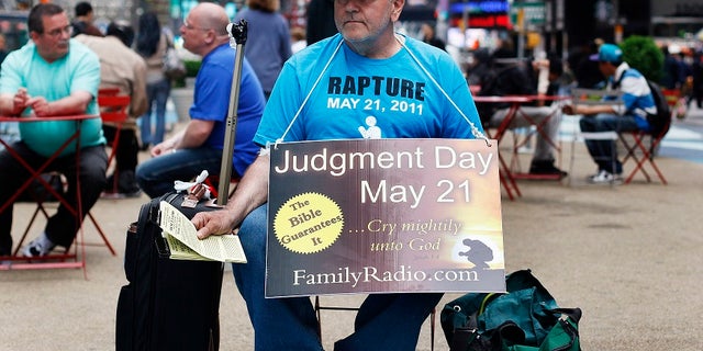 A volunteer from the religious group Family Radio hands out pamphlets warning of the impending Judgment Day. Harold Camping, an evangelist, predicted the end times would begin May 21, 2011.