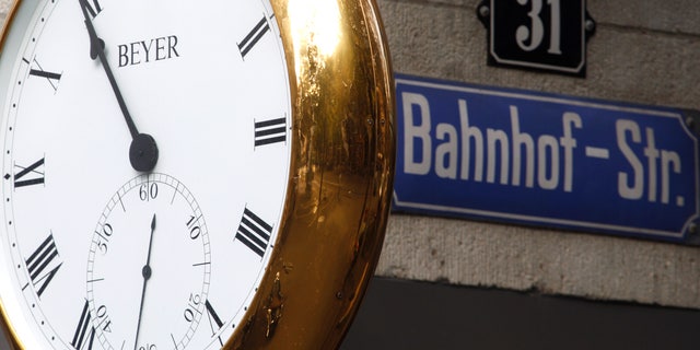 A clock displays the time on the facade of a jewellery and watch shop at Bahnhofstrasse in Zurich October 3, 2011.
