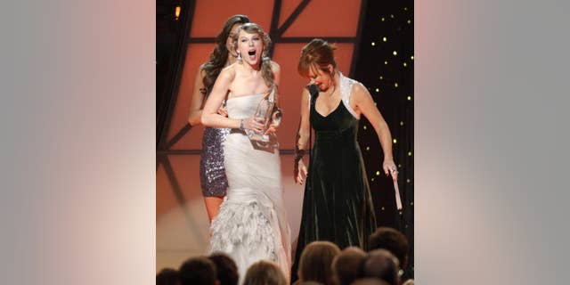 Reba McEntire gave away many awards over the years that she hosted and co-hosted the ACM Awards. In 2010, she awarded Taylor Swift with "Entertainer of the Year."