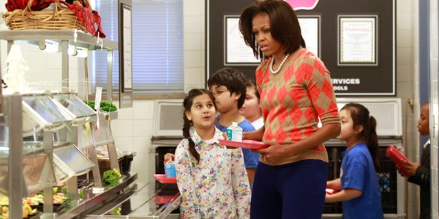January 25, 2012: U.S. First Lady Michelle Obama joins the lunch line at Parklawn Elementary School in Alexandria, Virginia. Obama made the visit to speak about the United States Department of Agriculture's (USDA) new and improved nutrition standards for school lunches.
