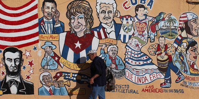 A man walks by a mural in the Little Havana neighborhood of Miami, Florida January 26, 2012. Florida Republicans will go to the polls on January 31 to choose among the party's candidates hoping to challenge President Barack Obama in the November general election.
Hispanics and non-Hispanic blacks each make up about 13 percent of Florida's registered voters, while non-Hispanic whites account for 68 percent. REUTERS/Shannon Stapleton (UNITED STATES - Tags: POLITICS ELECTIONS SOCIETY) - RTR2WX03