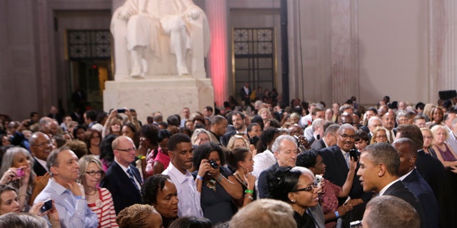 U.S. President Barack Obama (R) shakes hands with supporters after speaking at a campaign fund raising event at the Franklin Institute in Philadelphia, Pennsylvania June 12, 2012. In the background is a statue of U.S. founding father Benjamin Franklin.
REUTERS/Kevin Lamarque (UNITED STATES - Tags: POLITICS) - RTR33IIA