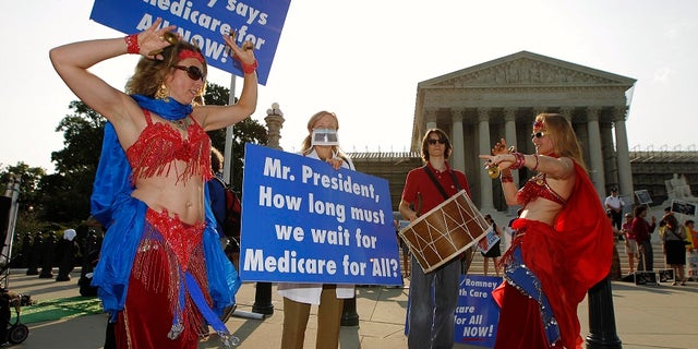 Belly dancers outside of the Supreme Court in 2012 call for a single-payer national health insurance program as the nation's highest court was set to rule on the Obama administration's health care overhaul.