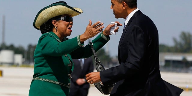 Rep. Frederica Wilson, D-Fla., greets then-President Barack Obama after he arrived in Miami in 2012.