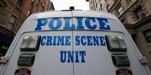 A New York City Police Crime Scene Unit vehicle stands on West 75th street 