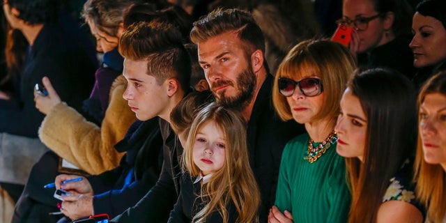 David Beckham with daughter, Harper, at New York Fashion Week event. (Reuters)